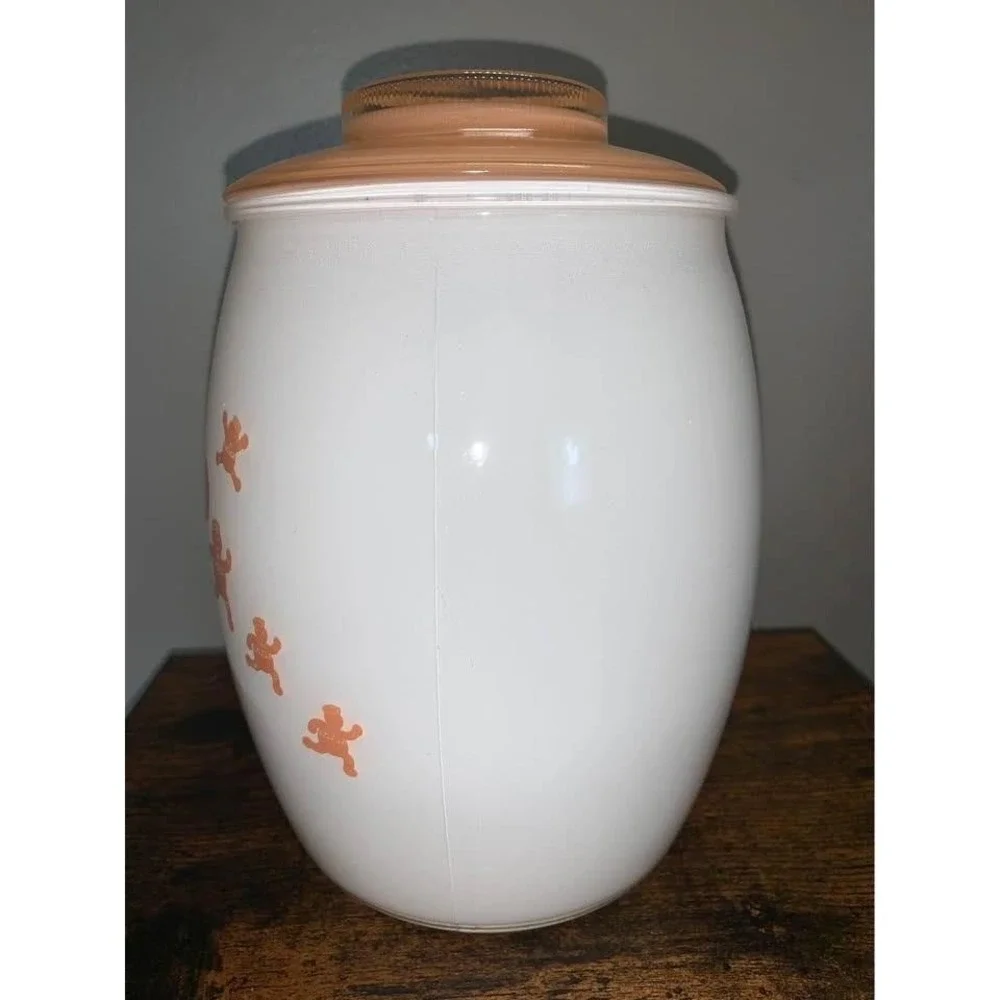 Vintage Bartlett Collins milk glass cookie jar featuring gingerbread man design